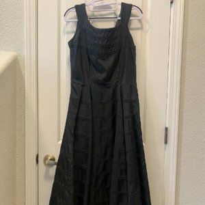 1950s vintage black horizontal pleated mid-calf satin dress